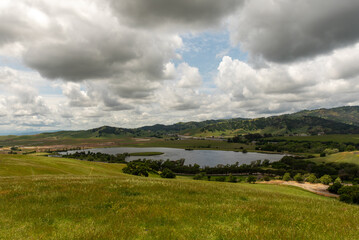 The Lagoon Valley Park lake in Vacaville, California, USA, viewed from a hill, including the highway I-80 at a distance - 715006735