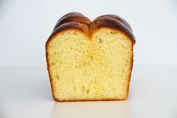 Delicious brioche bread sliced on a white background. Classical French yeast bread.