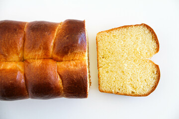 Delicious brioche bread sliced on a white background. Classical French yeast bread. Top view.