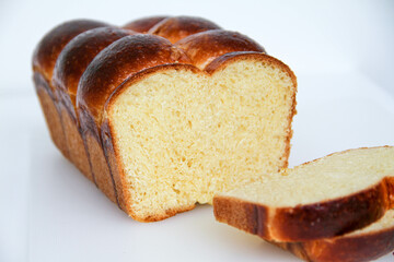 Delicious brioche bread sliced on a white background. Classical French yeast bread.