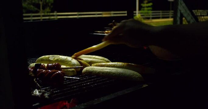 Scene of a man grilling banana in a delicious way.