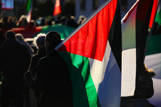 Palestinian backlit flags carried by demonstrators during the protest march for freedom and independence