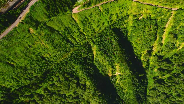 Aerial shot picturesque nature of Sete Cidades in Azores with lush green hills, abandoned Monte Palace hotel on hilltop. Ponta Delgada Island, Sao Miguel, Portugal. Travel destination, touristic place