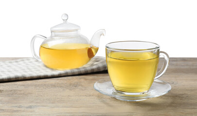 Refreshing green tea in cup and teapot on wooden table against white background