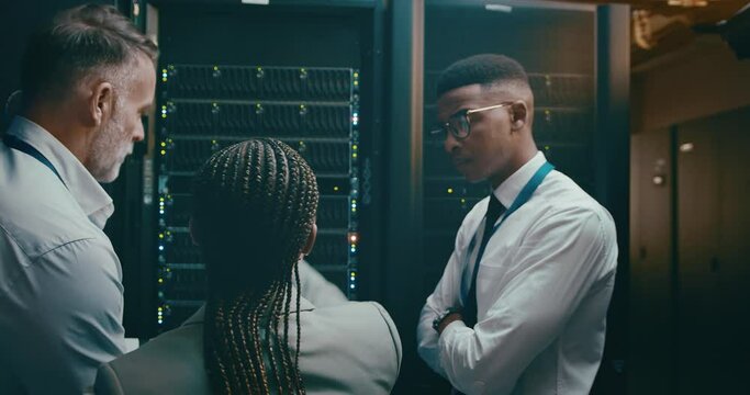 People, technology and server room planning, tablet programming or cloud computing solution. Back of manager, technician and group in data center for system, digital and hardware problem solving