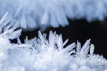 Ice crystals macro in close-up view shows beautiful ice structures of frozen water with spikey...