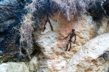 Prehistoric cave paintings, with figures of animals and men, painted on the surface of a rock