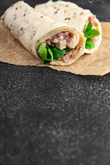 wrap ham, vegetable, cheese, lettuce tortilla fresh tasty eating cooking appetizer meal food snack on the table copy space food background rustic top view