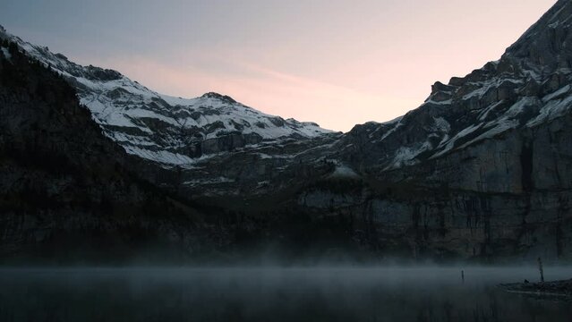 Mysterious morning mist over mountain lake. Stady shot