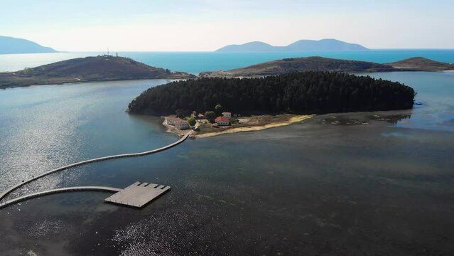 Drone aerial view on isolated Monastery of Saint Mary on Zvernec island Narta Lagoon, Vlore, Albania