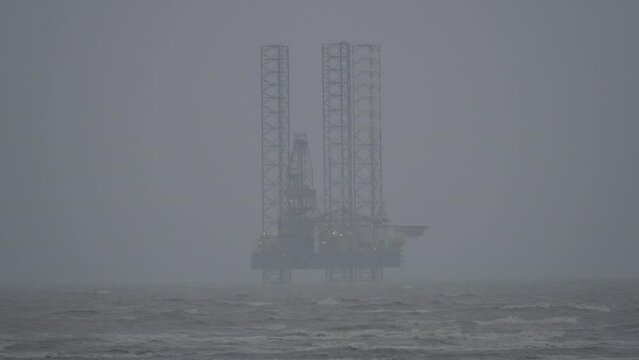 Gas rig situated off Ainsdale beach on cloudy and stormy day