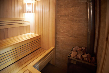 Interior of Finnish sauna, classic wooden sauna with hot steam. Russian bathroom.