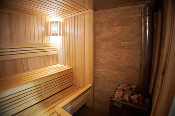Fototapeta na wymiar Interior of Finnish sauna, classic wooden sauna with hot steam. Russian bathroom.