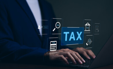 Tax concept. Businessman using laptop to complete individual income tax return form online for tax...