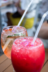 close up of young red and rosatto cocktail glasses on bistro table with crushed ice