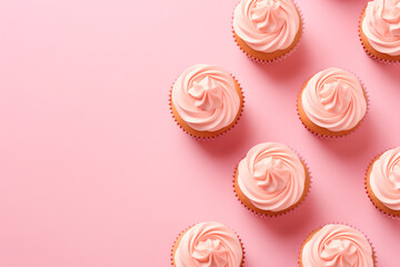 Flatlay with pink cupcakes on a pink background. Festive image for bakery's advertisement or children's birthday party service. Design for a cafe or dessert shop. Banner with copy space