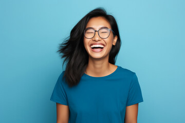 Attractive asian woman isolated on blue background