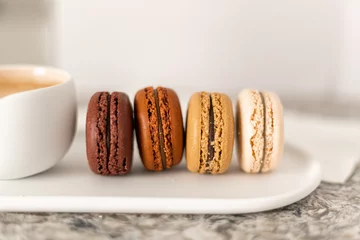 Foto op Plexiglas Assorted macarons for dessert in chocolate, hazelnut, coffee and vanilla © Erica