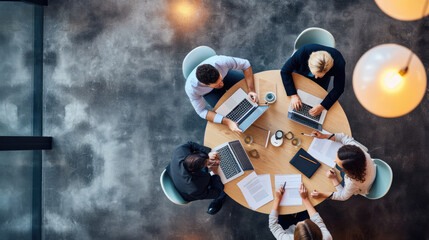 Aerial view of a professional meeting with four individuals around a round table
