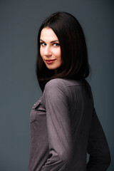 Fototapeta premium Woman With Long Black Hair Poses for Picture. A woman with mesmerizing long black hair strikes a pose, ready for her picture to be taken.