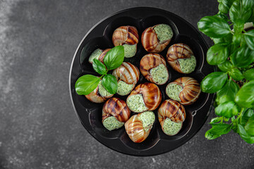 snails with green oil aromatic herbs tasty fresh healthy eating cooking appetizer meal food snack on the table copy space food background