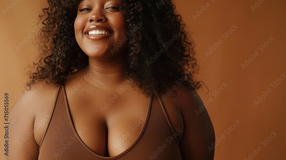 Poster a woman in a brown tank top smiling at the camera. suitable for various applications