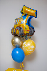 balloons with a tractor, the inscription on the balloon "Happy Birthday". Balloons for a boy for a holiday on a white background