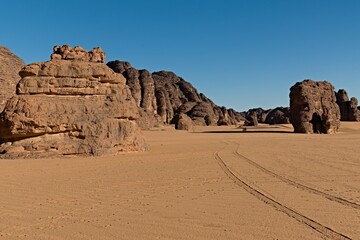 Fototapeta na wymiar Tikoubaouine rock formations in the tourist area of Immourouden, near the town of Djanet. Tassili n Ajjer National Park. Sahara desert. Algeria. Africa.