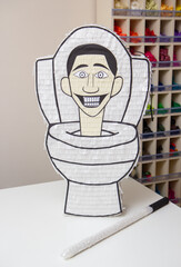 piñata white toilet with a head from the toilet, holiday decor