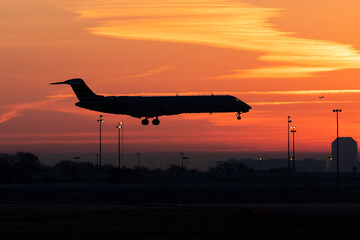 Passenger aircraft silhouette against a brilliant Texas sunrise