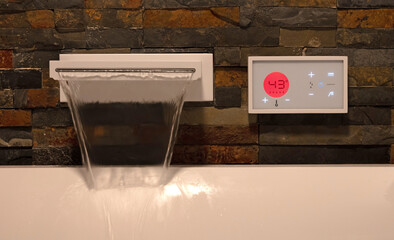 Modern digital watertap, filling the white bath