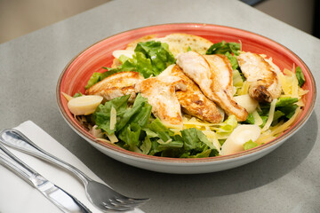 salad plate with healthy grilled chicken breast in restaurant