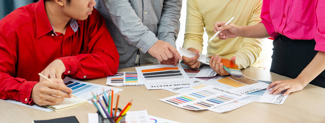 A cropped image of professional interior designer discuss the color material with her colleagues by...
