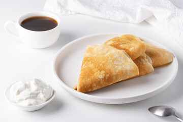 Thin pancakes in a plate. Concept of delicious breakfast or Maslenitsa