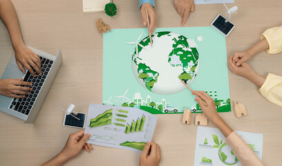 Green city illustration placed on a meeting table during a green business meeting discussion. ESG...