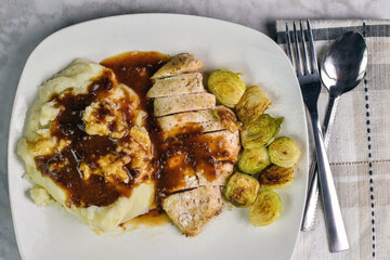 chicken breast served with mash potatoes and gravy
