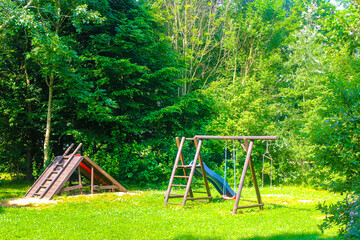 Wooden tower with slide and stairs on playground in park