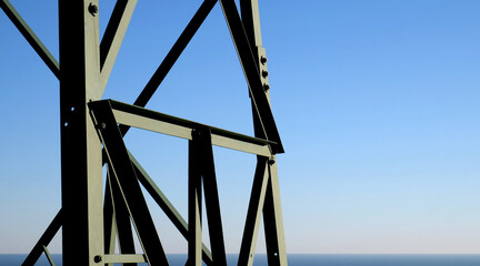 Supporting structure of an electric pylon on the sea - obrazy, fototapety, plakaty