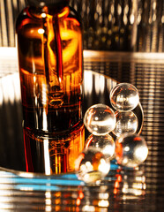 Cosmetic jar. Night serum for face on a dark background. Reflections on a dark background. Vertical photography for cosmetics business. The radiance of beauty.