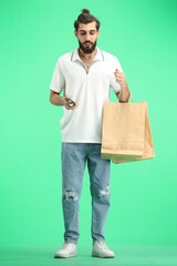 A man, full-length, on a green background, with bags