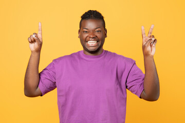 African guy raising hands showing one and two fingers, studio