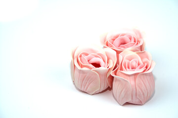 Three pink roses in close-up. Delicate background for a postcard, banner, photo wallpaper, cover, poster.