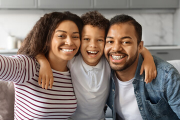 Happy Young Black Parents Taking Selfie With Little Son At Home