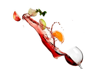 Sangria with red wine and fresh fruits splash from a glass on white background