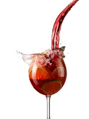 Sangria with red wine and fruits pour and splash in a glass on white background - 715095337
