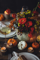 Fall table decoration with pumpkins, wine. Family cozy thanksgiving dinner arrangement indoors at home, wedding elegant decor. Countryside style, simple handmade setting, autumn mood, inspiration.