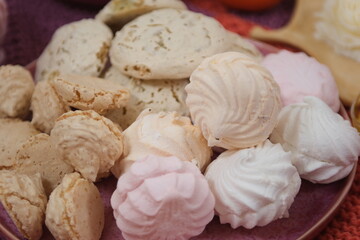 Marshmallow production. Fresh, sweet, multi-coloured marshmallows just cooked at a confectionery factory are sent for packing. High quality