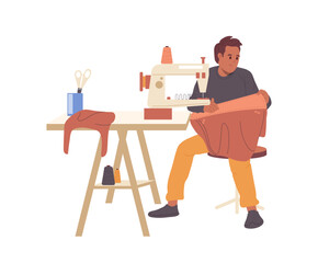 Young man sewing female fashion bag from leather on machine during manufacturing process at workshop