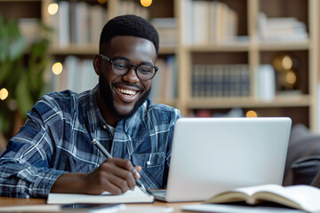 Obraz premium Smiling student, diligently studying in the library, concentrating on the books on the table.