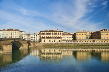 Fototapeta na wymiar View of the river Arno and buildings from the embankment in Florence. High quality photo